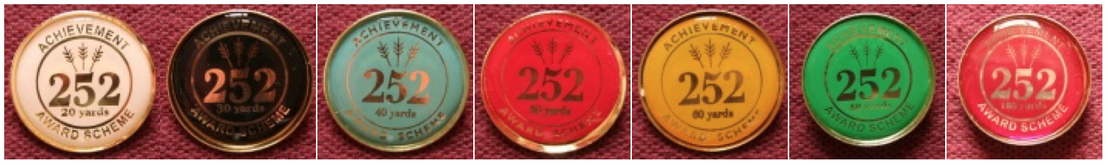 The seven 252 Award Scheme badges: white 20 yards, black 30 yards, blue 40 yards, red 50 yards, gold 60 yards, green 80 yards and pink 100 yards